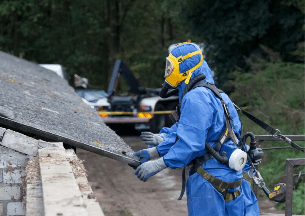 Licensed asbestos inspector in full protective gear carefully assessing an old Brisbane roof with professional tools, emphasizing safe inspection before spring.